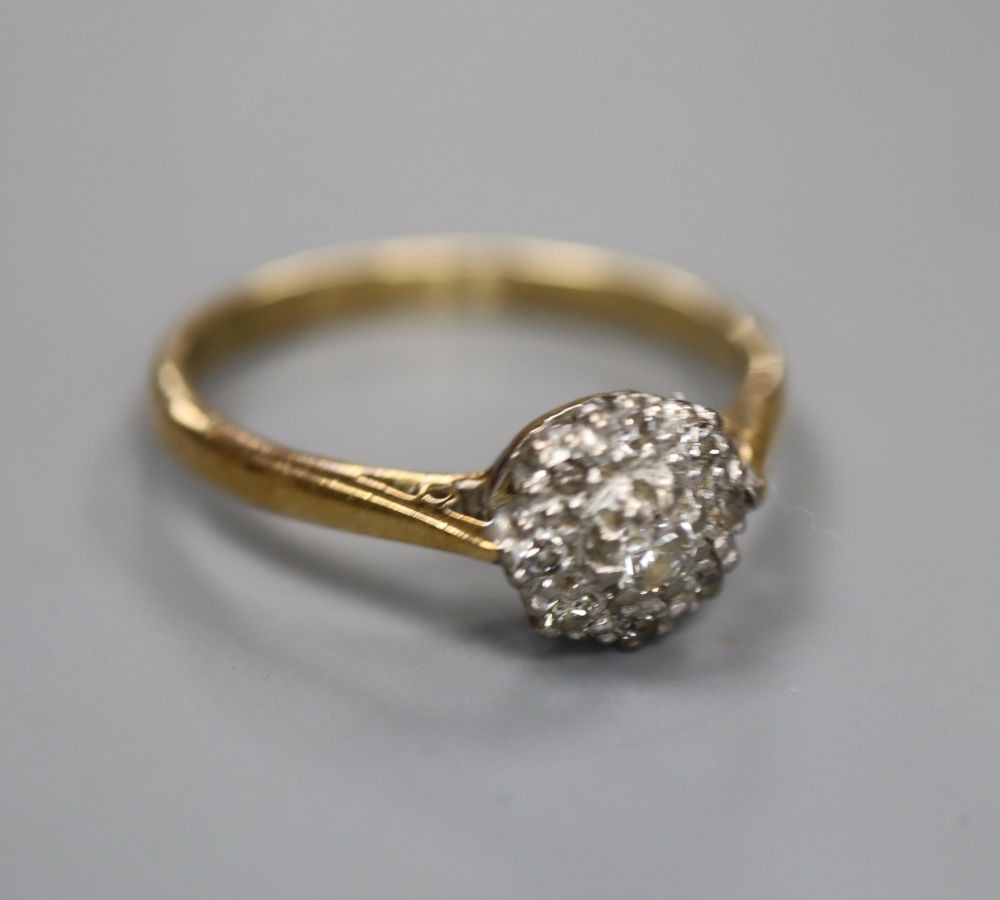 An 18ct, plat and diamond circular cluster ring, size O, gross 2.7 grams.